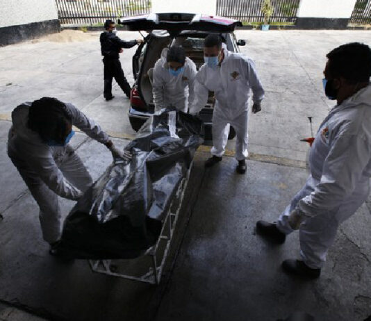 Trabajadores de una funeraria trasladan el cuerpo de una víctima de Covid-19 al crematorio del Panteón San Nicolás Tolentino de Iztapalapa. Foto Ap.