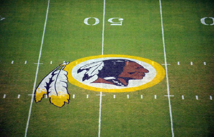 En imagen de archivo, el logo de los 'Pieles Rojas' se muestra en el campo antes del inicio de un partido de pretemporada de la NFL contra los Patriotas de Nueva Inglaterra en Landover, Maryland. Foto Ap.